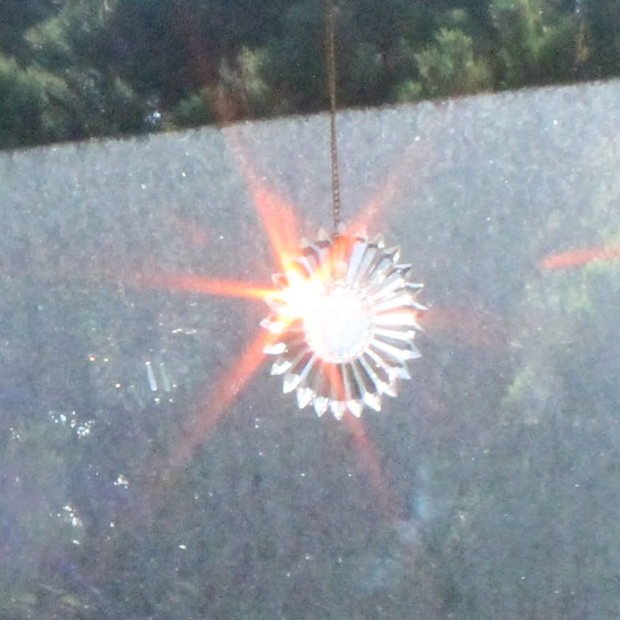 5-inch prism suncatcher flashing a sunbeam toward the camera