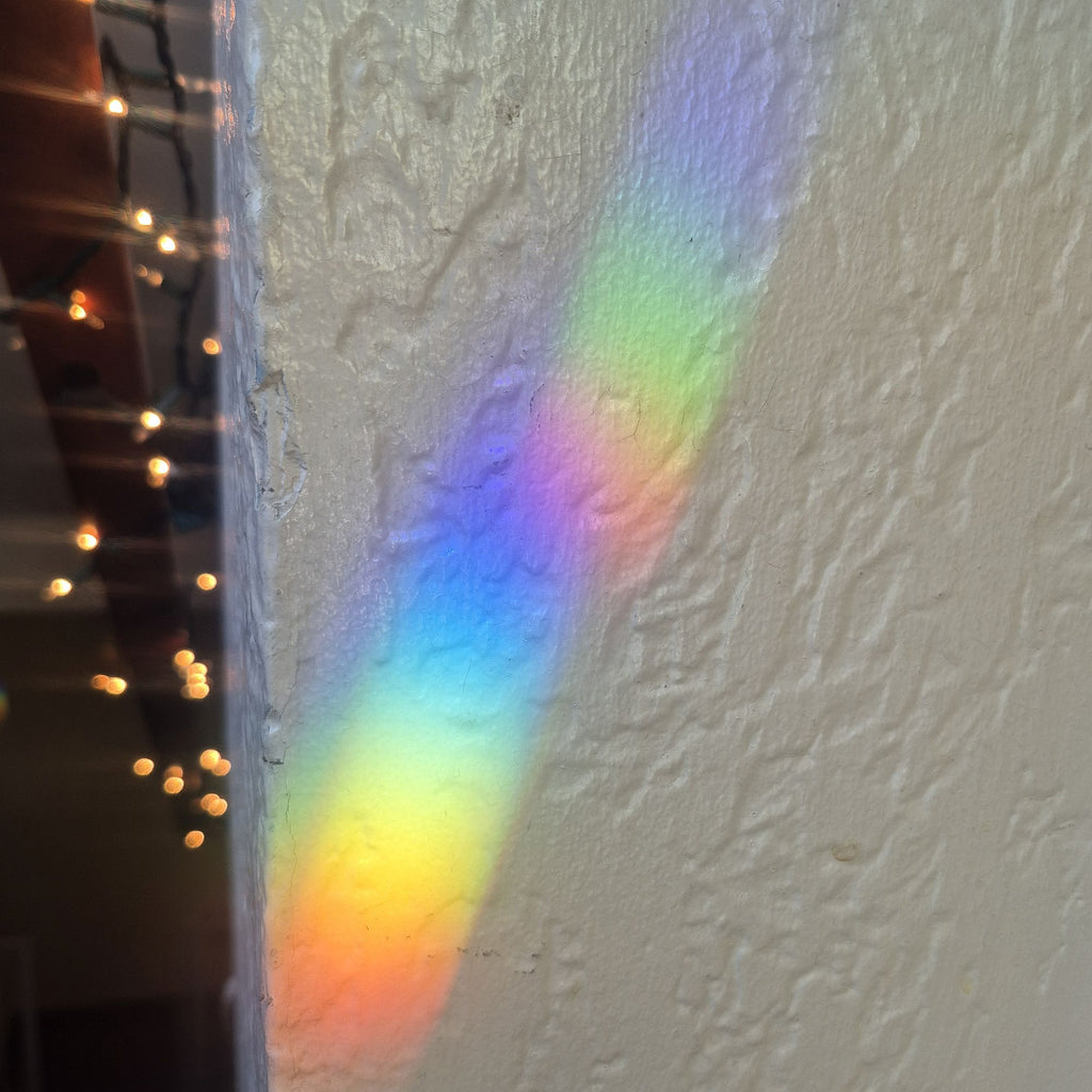 two rainbow spectra overlayed on a textured wall