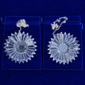 two clear 6-inch diameter prism suncatchers with silver-colored chains resting on a blue background