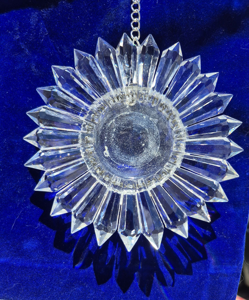 a sparkling 5-inch prism suncatcher on a blue velvet bag