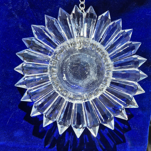 a sparkling 5-inch prism suncatcher on a blue velvet bag