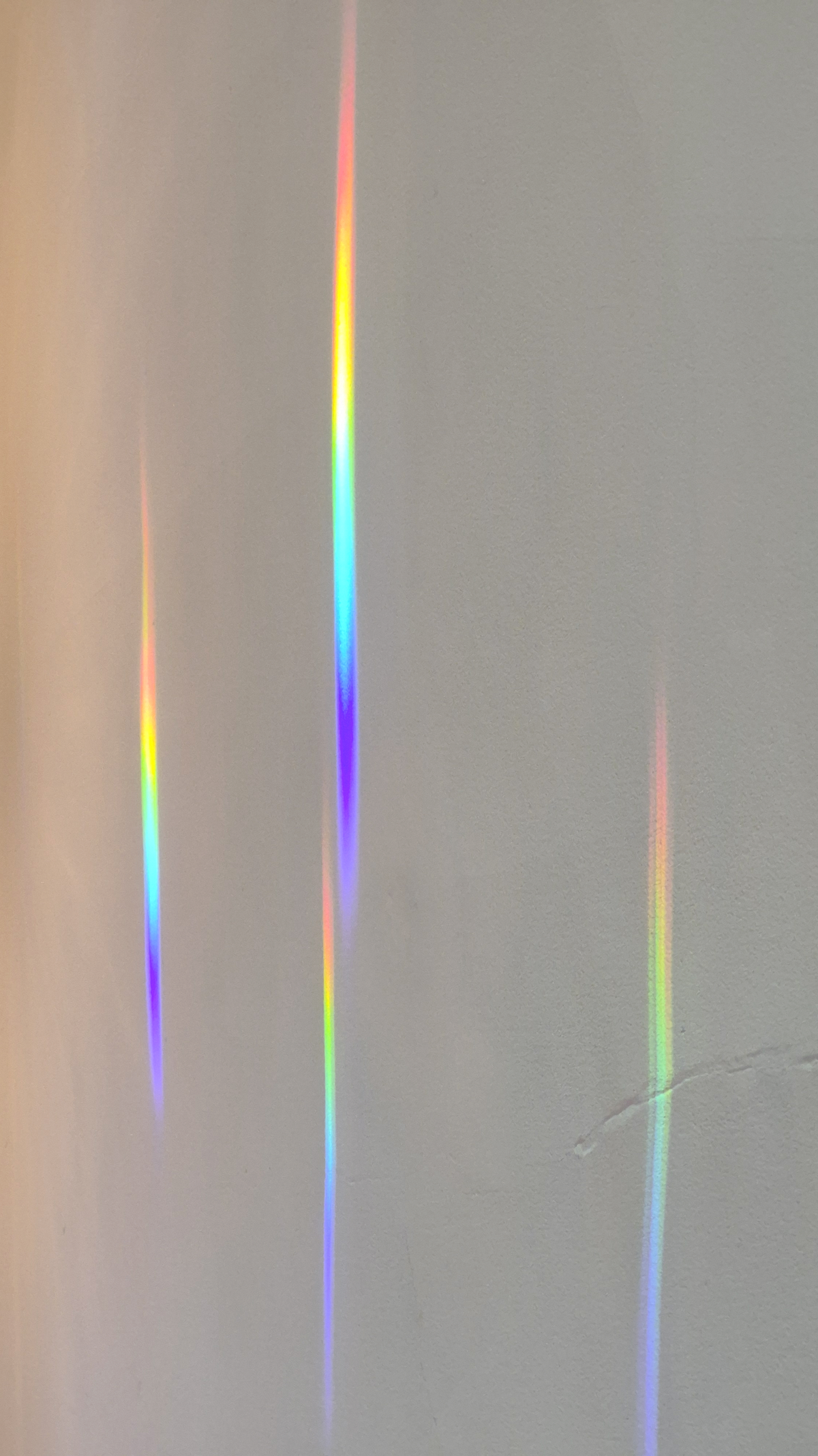 streaks of rainbow light on the dining room ceiling