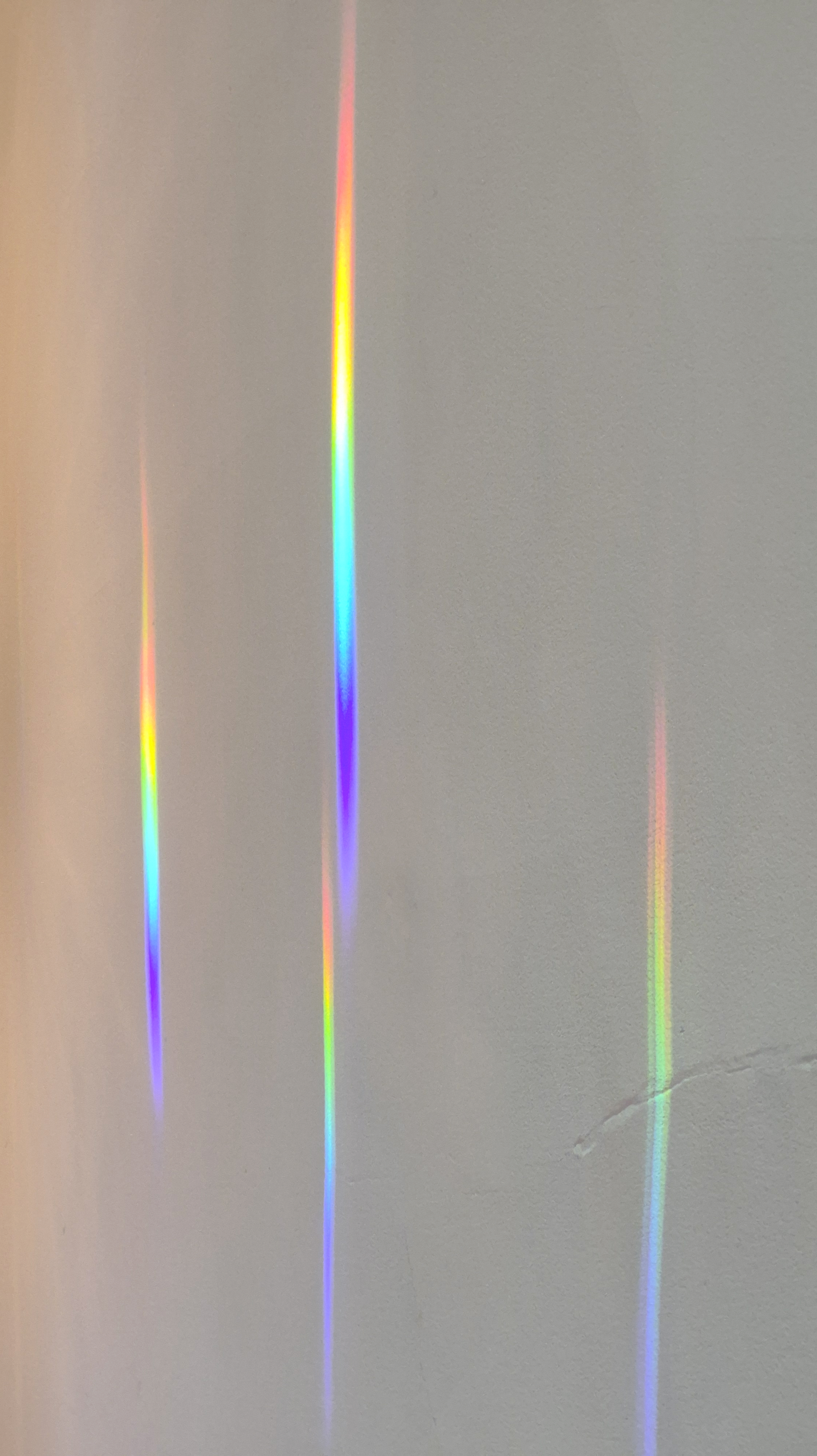 streaks of rainbow light on the dining room ceiling
