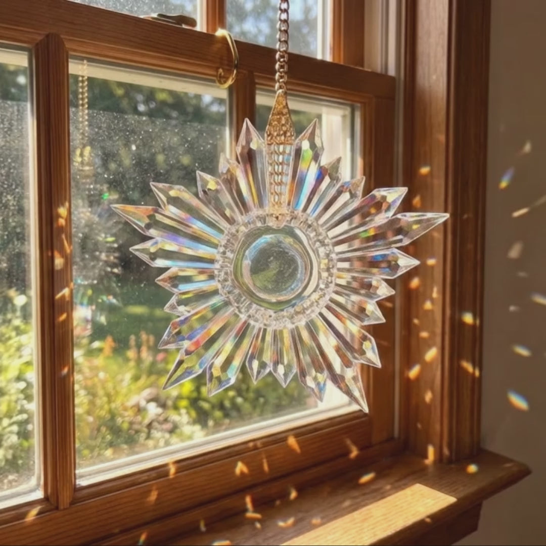 video of front and side view of a star-shaped clear prism suncatcher hanging in a sunny window casting light spectrums all around it